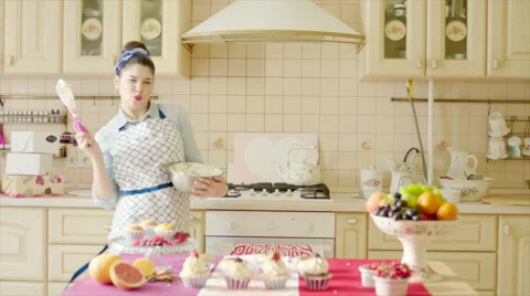 Girl dancing with utility whisk in the kitchen Stock Footage 62747030