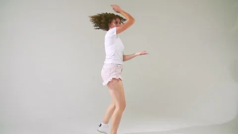 Girl dancing on a white background Stock Footage 141457507