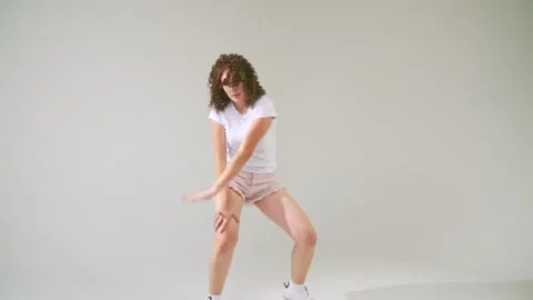 Girl dancing on a white background Stock Footage 141606992