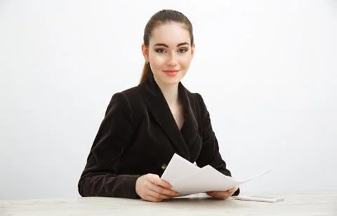 Girl in dark jacket holding a stack of documents Stock Photos