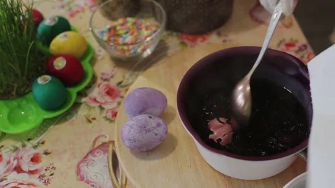 The girl decorates Easter eggs in a solution Stock Footage 76645217