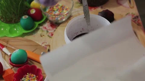 The girl decorates Easter eggs in a solution.Close-up Stock Footage 76645762