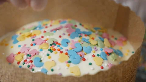 A girl decorates a holiday cake. Easter cake with colored glaze. Festive Stock Footage 130348587