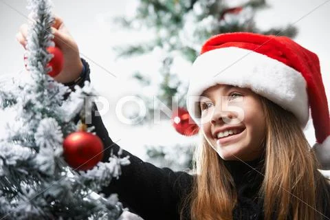 Girl Decorating The Christmas Tree
