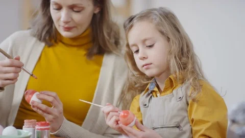 Girl Decorating Easter Egg and Smiling for Camera Stock Footage 126343873