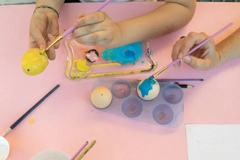 Girl decorating Easter eggs Stock Photos