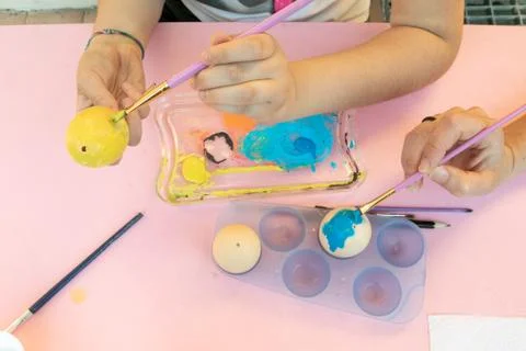 Girl decorating Easter eggs Stock Photos