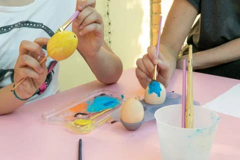 Girl decorating Easter eggs Stock Photos