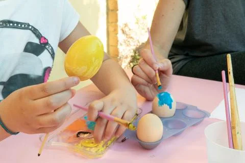 Girl decorating Easter eggs Stock Photos