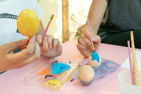Girl decorating Easter eggs Stock Photos
