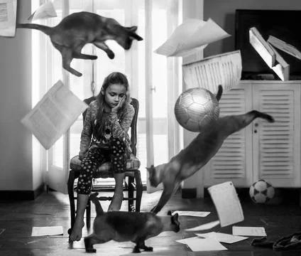 Girl deep in thoughts with objects flying around Foto stock