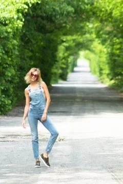 Girl in denim overalls Foto stock