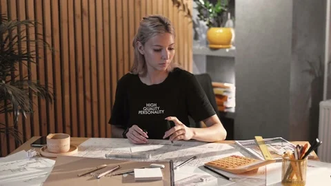 Girl designer in the office making notes about her work in a notebook Vídeos de archivo 223118268