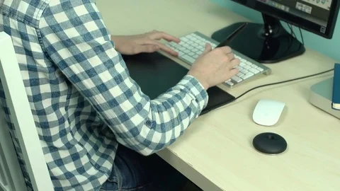 Girl designer working at computer using stylus and graphic tablet close-up 4k. Stock Footage 79672225