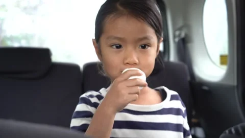 A Girl Devouring Boiled Eggs in a Car Video stock 333185576