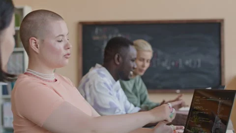 Girl Discussing Code on Laptop with Groupmate on Programming Class Stock Footage 257062134