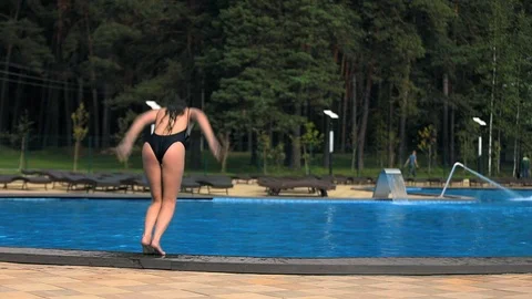 Girl dives into the pool Stock Footage 95771008