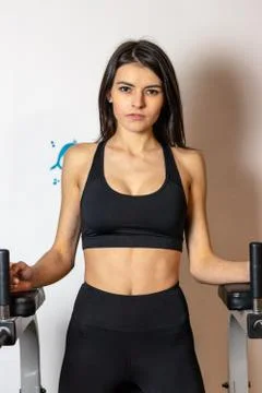 The girl does exercise on the press on the simulator in the gym Stock Photos