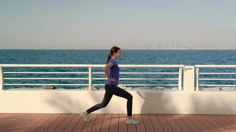 Girl does exercises outside Video stock 129821623