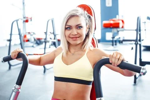 The girl does exercises on simulators Stock Photos