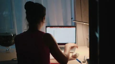 Girl does homework in the evening, uses a laptop Stock Footage 130644281