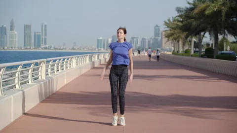Girl does jumping-jack outside Video stock 129821203