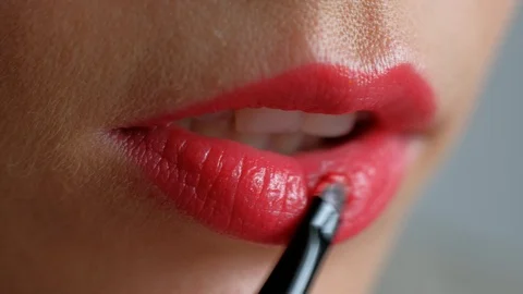 The girl does makeup on her lips. Applying red lipstick to lips. Close-up. Stock Footage 103420085