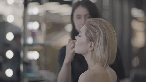 Girl does makeup by the mirror Stock Footage 99657740