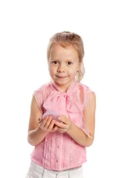 Girl does makeup using lip gloss, looking in a small hand mirror Foto stock