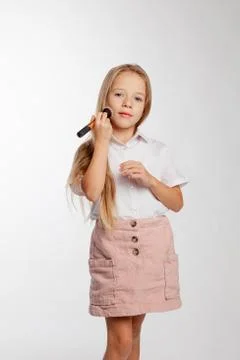 Girl does makeup using a powder brush Foto stock