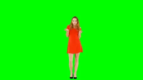 Girl Does Not Know What Is Going On Spreading Hands on Green Screen Stock Footage 99511807