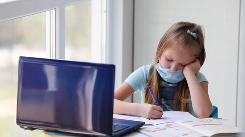 The girl does online lessons, homework and looks out the window. Stock Footage 128986460