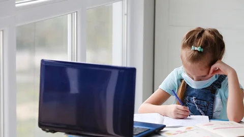 Girl does online lessons, homework and looks out the window. Stock Footage 128986549