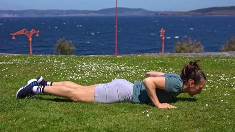 The girl does physical exercises on the grass. Stock Footage 197386978