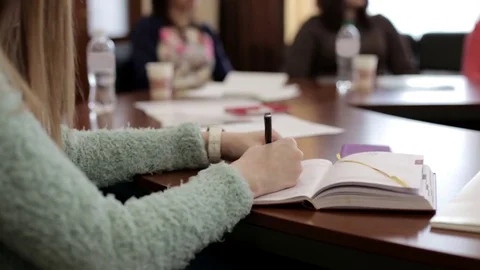 The Girl Does Records in a Notebook Stock Footage 72529856