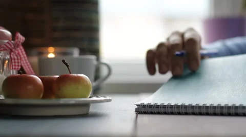 The girl does records in a notebook at the table Stock Footage 68907953