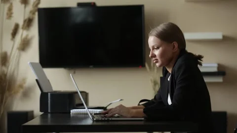 Girl does work from home on a remote computer at a desk with a notebook Stock Footage 139106670