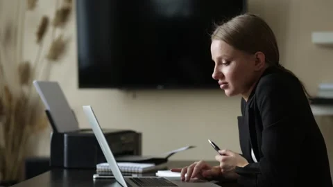 Girl does work from home on a remote computer at a desk with a notebook Stock Footage 139106755