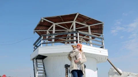 The girl with the dog on the background of the lighthouse. Video stock 74912658