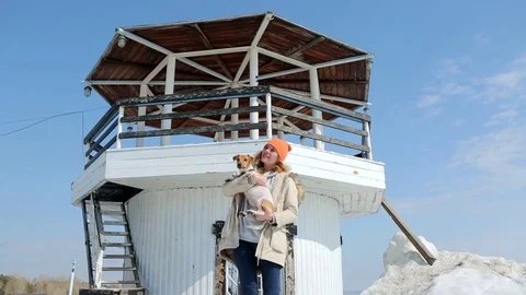 The girl with the dog on the background of the lighthouse. Stock Footage 74912992