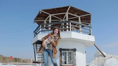 The girl with the dog on the background of the lighthouse. Video stock 74913435