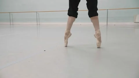 A girl doing ballet in an empty hall stretches her legs before a rehearsal Stock Footage 171231555