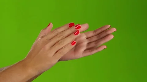 Girl doing claps her hands on a green screen background Stock Footage
