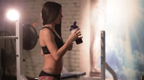 Girl doing exercise and drinking water Stock Footage 56345120