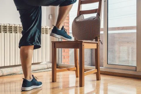 Girl doing exercise with a chair Stock Photos