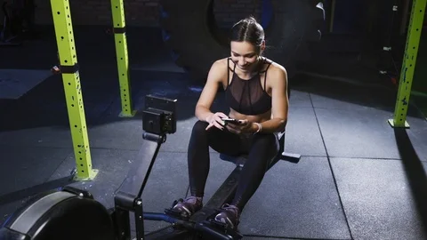 Girl doing exercise on rowing machine Stock Footage 123075283