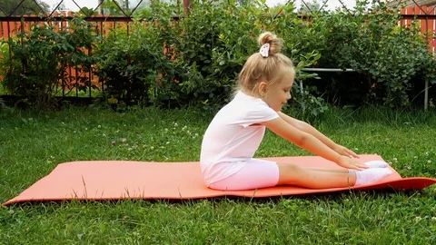 Girl doing exercises on the grass Stock Footage 115633174