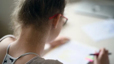 Girl doing homework and taking notes Stock Footage 88567595