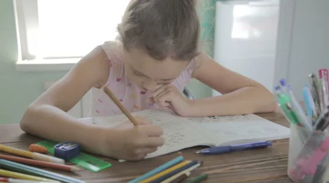 Girl is doing homework for elementary school. Vídeo Stock 52323484