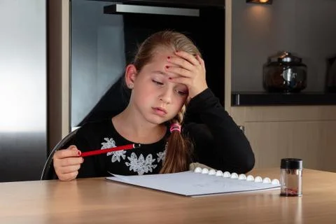 Girl doing homework thinking Stock Photos